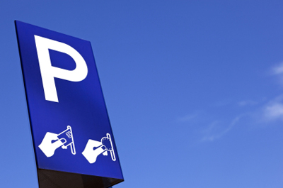 a blue parking sign against a blue sky to show the sample vendor for developing a white paper topic