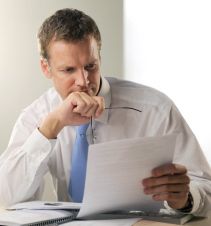 man wondering if he's looking at a white paper