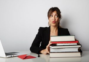 photo of book editor with pile of books