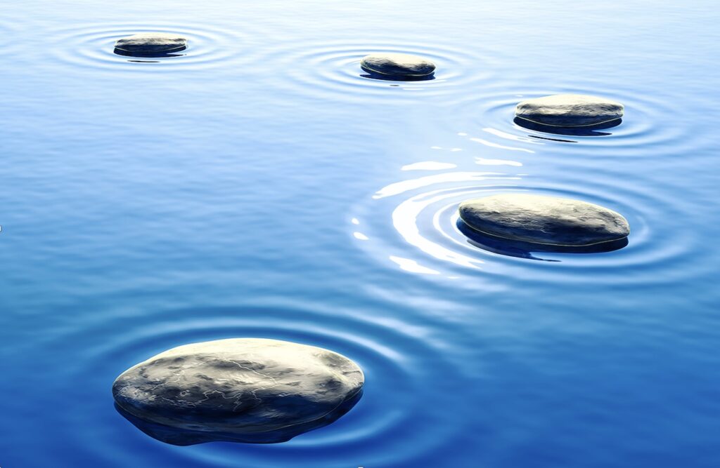 5 stepping stones in a blue lake