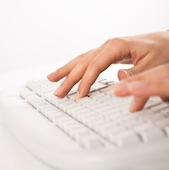 photo of fingers typing on keyboard