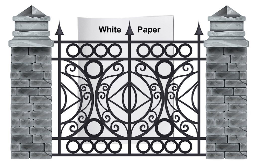 white paper behind a brick and wrought iron gate