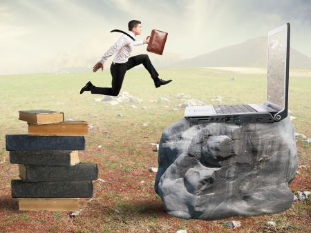 photo of a copywriter jumping from a pile of books to a laptop