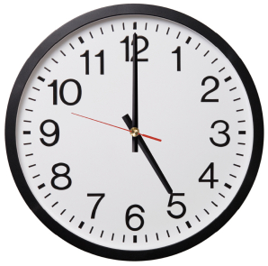 round clock showing 5 PM