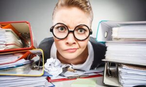 Crazed researcher with desk piled high with sources