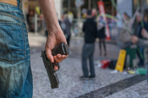 man holding pistol in public place