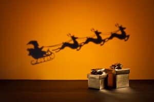 shadow of Santa's sleigh with presents in foreground