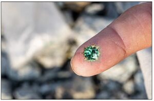 closeup on emerald on miner's finger
