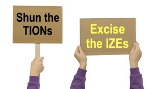 Two placards reading Shun the TIONs and Excise the IZEs