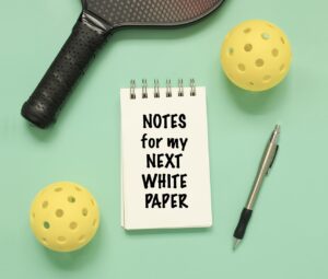 pickleball racquet balls and notepad 